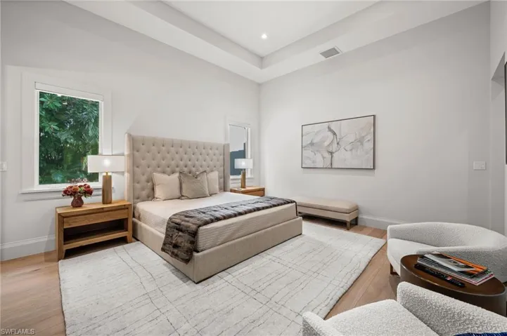 Bedroom with baseboards, wood finished floors, and recessed lighting