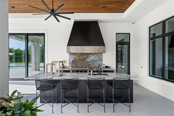 View of patio featuring a grill and ceiling fan