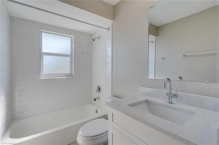 Bathroom with vanity and shower / tub combination