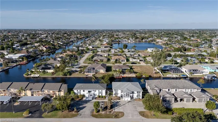 Aerial perspective of suburban area with a nearby body of water