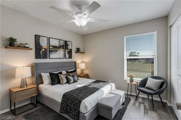 Bedroom with a closet, wood finished floors, and a ceiling fan