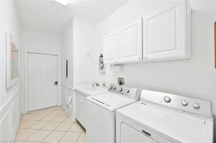 Spacious laundry area w/wash tub and large storage closet