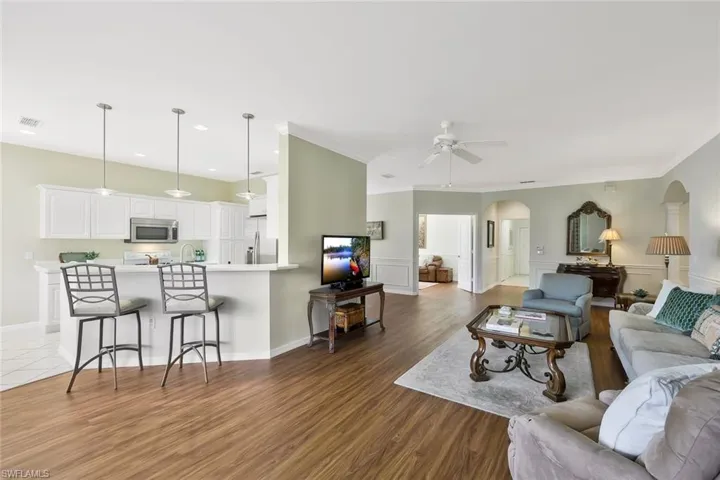 Living room to kitchen with breakfast bar seating.