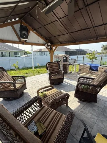 Fenced backyard with a patio, outdoor lounge area, and a residential view