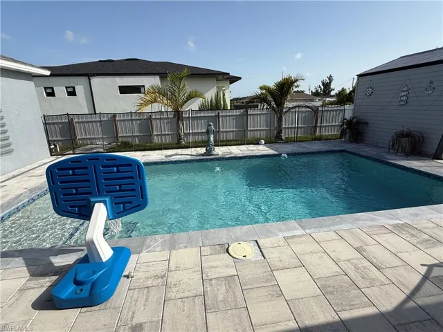 View of swimming pool with a patio area and a fenced backyard