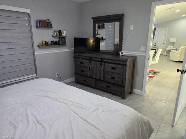 Bedroom featuring light tile patterned floors and recessed lighting