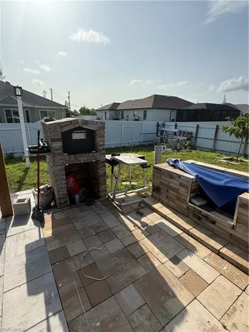 Fenced backyard featuring a patio and a residential view