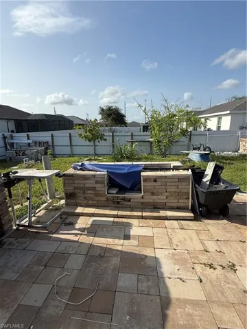 Fenced backyard featuring a patio