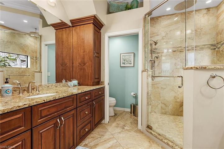 Master bath features dual sinks, large tiled shower, lots of storage.