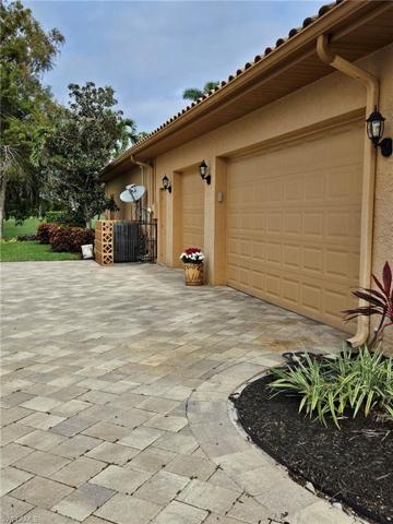 Side load, 3-car garage with brick paver drive.