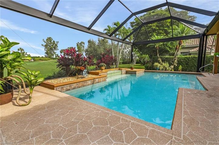 Beautiful pool area with water feature and new "picture window" screen.