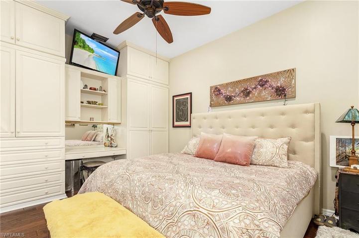 Guest room features lots of built-ins, wood floors, plantation shutters.