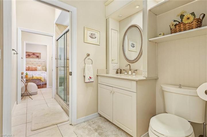Each half of the bath has a sink and toilet set up, with privacy door in-between, and share the shower.