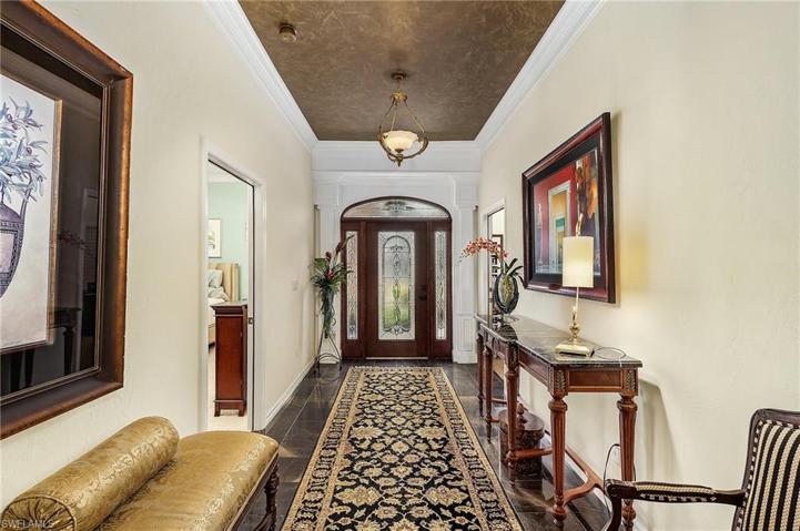 Stately entry with lead glass door, crown molding, tile floors.