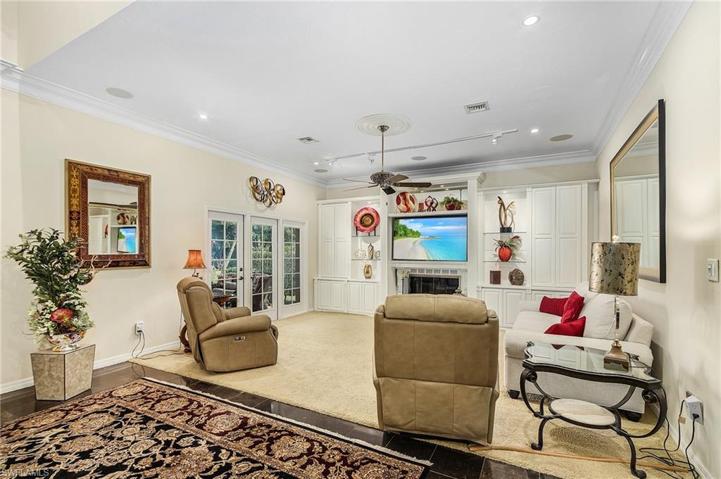 Great room has double French doors out to the screened lanai where there is a cozy sitting area.