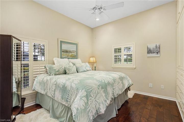 Guest room features lots of built-ins, wood floors, plantation shutters.