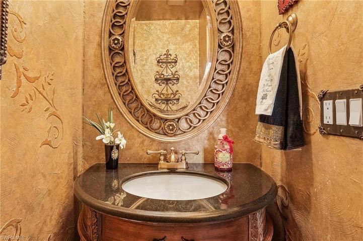 Powder bath is located just off the kitchen and can also be used as a pool bath.