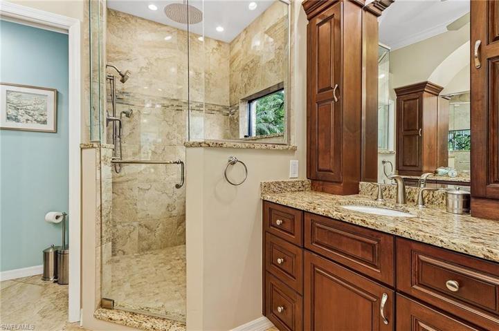 Master bath features cherry cabinetry, granite tops, tiled floors.