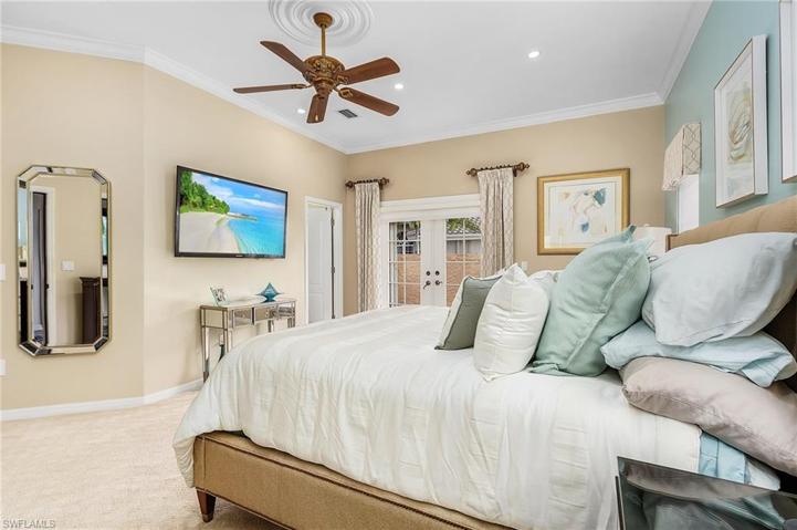 Master Suite features crown molding, French doors (with hurricane shutters) to private deck, large walk-in closet, electric shades.