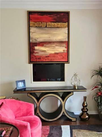 Family room features a hidden TV behind remote controlled artwork.