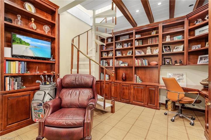 The den has custom built-in cherry cabinets, new carpet, spiral staircase to the loft/bonus room.