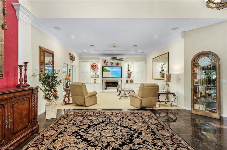 The great room features entertainment center built-ins, crown molding, surround sound, fireplace.