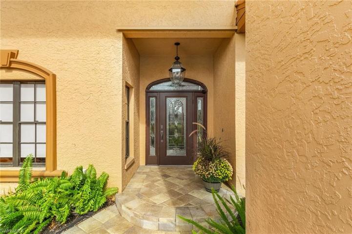 Brick paver walkway leads to a welcoming entry.