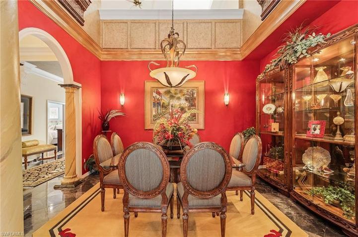 Stunning formal dining area with custom detailed craftmanship, volume ceiling, crown molding.