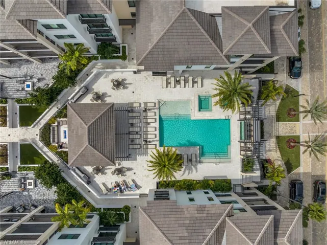Resort-style pool area featuring a rectangular pool and an integrated spa