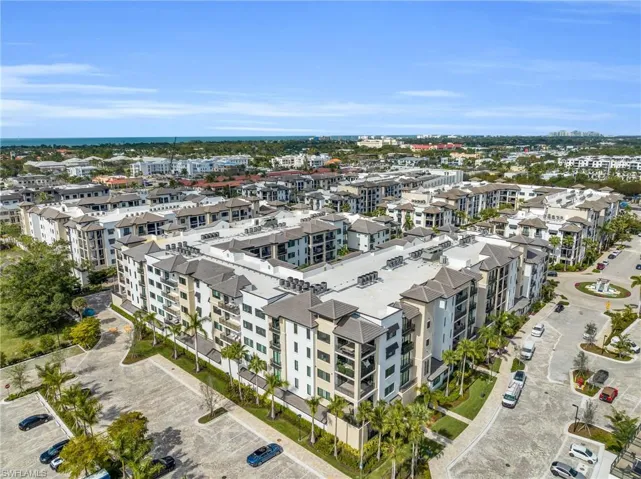 Multi-building complex with structured parking, integrated hardscaping, and surrounding landscaping