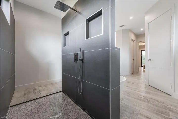 Hall with recessed lighting and wood finished floors
