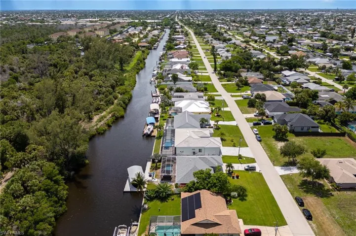 Aerial view of residential area featuring a large body of water