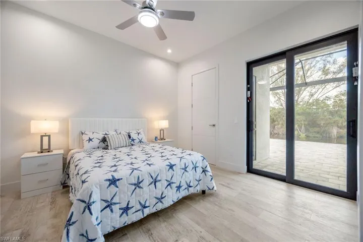 Bedroom with access to outside, light wood-style floors, recessed lighting, and ceiling fan