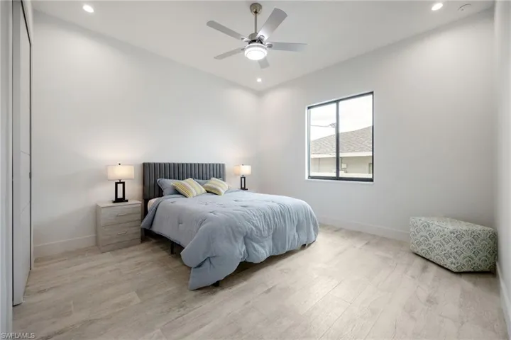 Bedroom featuring light wood-type flooring, recessed lighting, and a ceiling fan