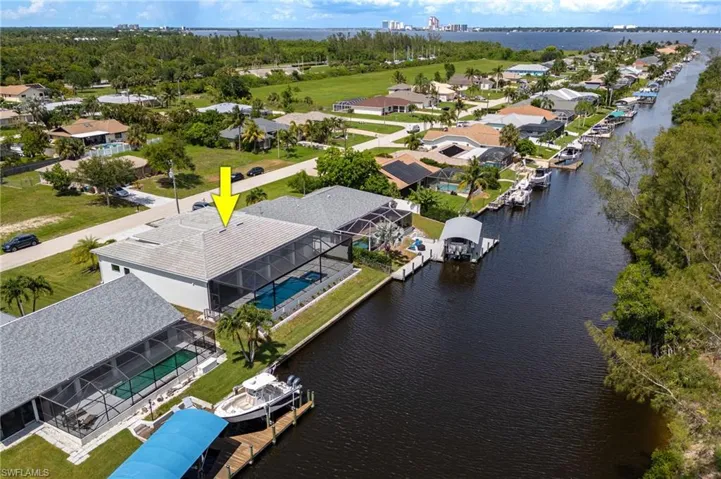 Aerial view of residential area featuring a large body of water