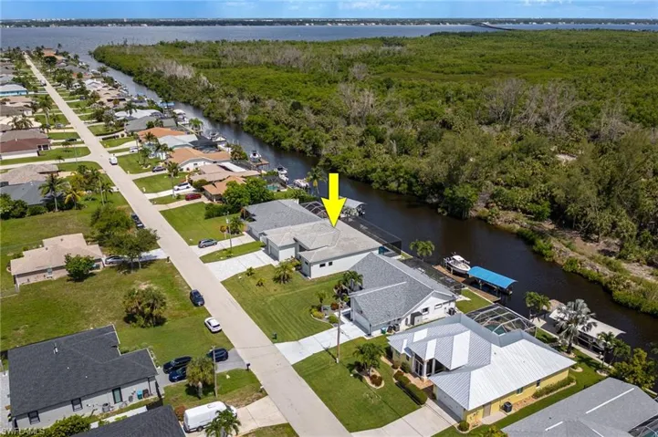 Aerial overview of property's location featuring a nearby body of water and nearby suburban area