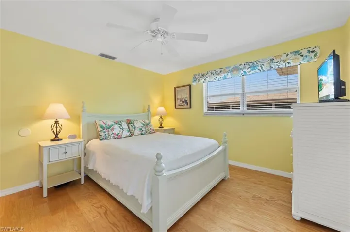 Bedroom with ceiling fan and light hardwood / wood-style floors