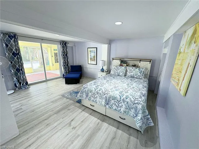 Bedroom featuring hardwood / wood-style floors and access to exterior