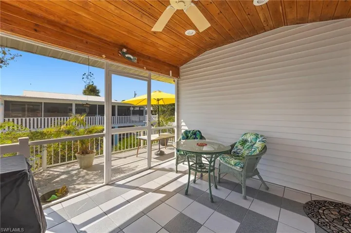 Sunroom featuring ceiling fan, vaulted ceiling, and wooden ceiling