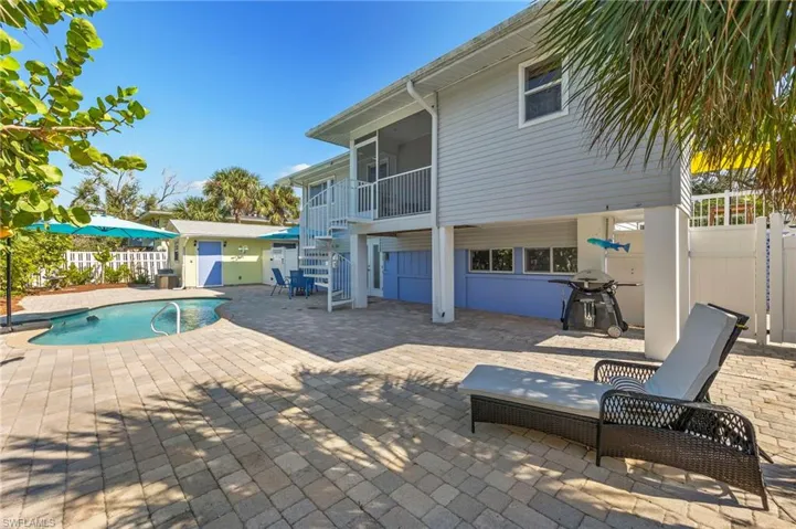 View of swimming pool featuring area for grilling and a patio area