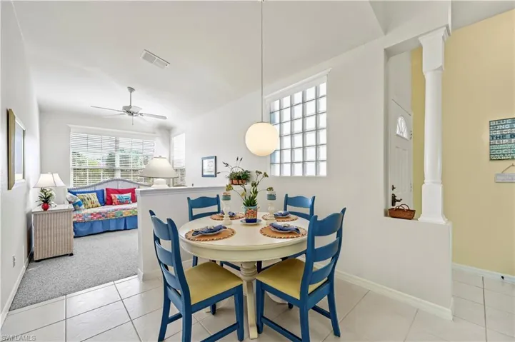 Dining area off of the kitchen (this image has been virtually edited to show seller's recent removal of wallpaper and window treatments in the dining area and den)