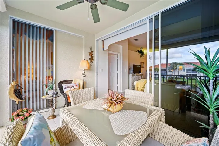 Living room with ceiling fan with notable chandelier and carpet floors