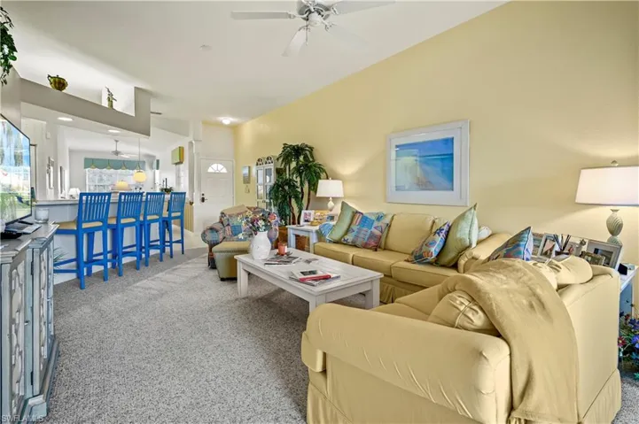 Living room with carpet and ceiling fan