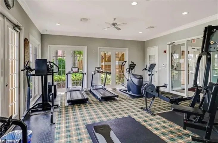 Gym with ceiling fan, french doors, and ornamental molding