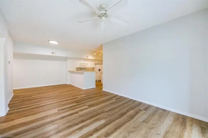 Unfurnished living room with ceiling fan and light hardwood / wood-style floors