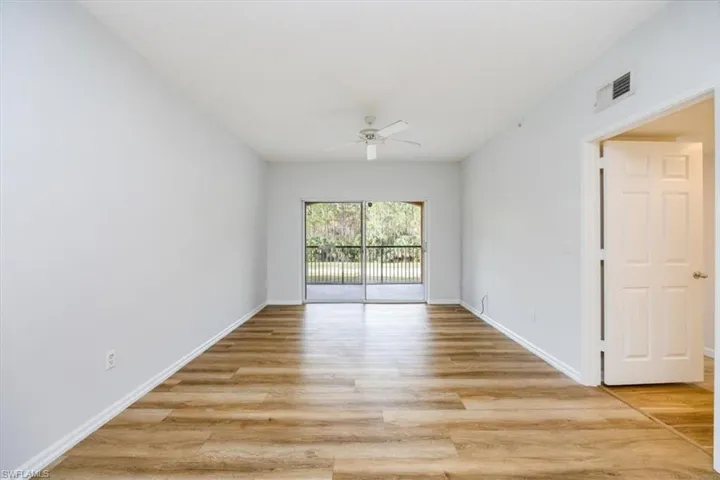 Spare room with ceiling fan and light wood-type flooring