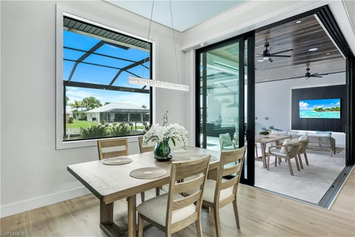 Dining space with light wood finished floors and ceiling fan