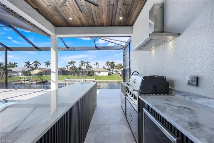 View of patio / terrace with glass enclosure, a residential view, a grill, and area for grilling