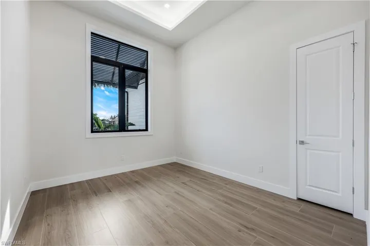 Empty room featuring baseboards and light wood finished floors