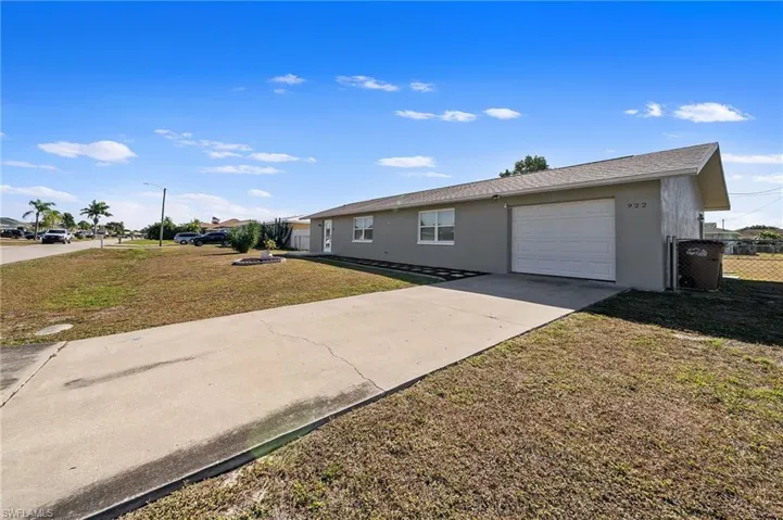 Ranch-style home featuring stucco siding, concrete driveway, a garage, and roof with shingles